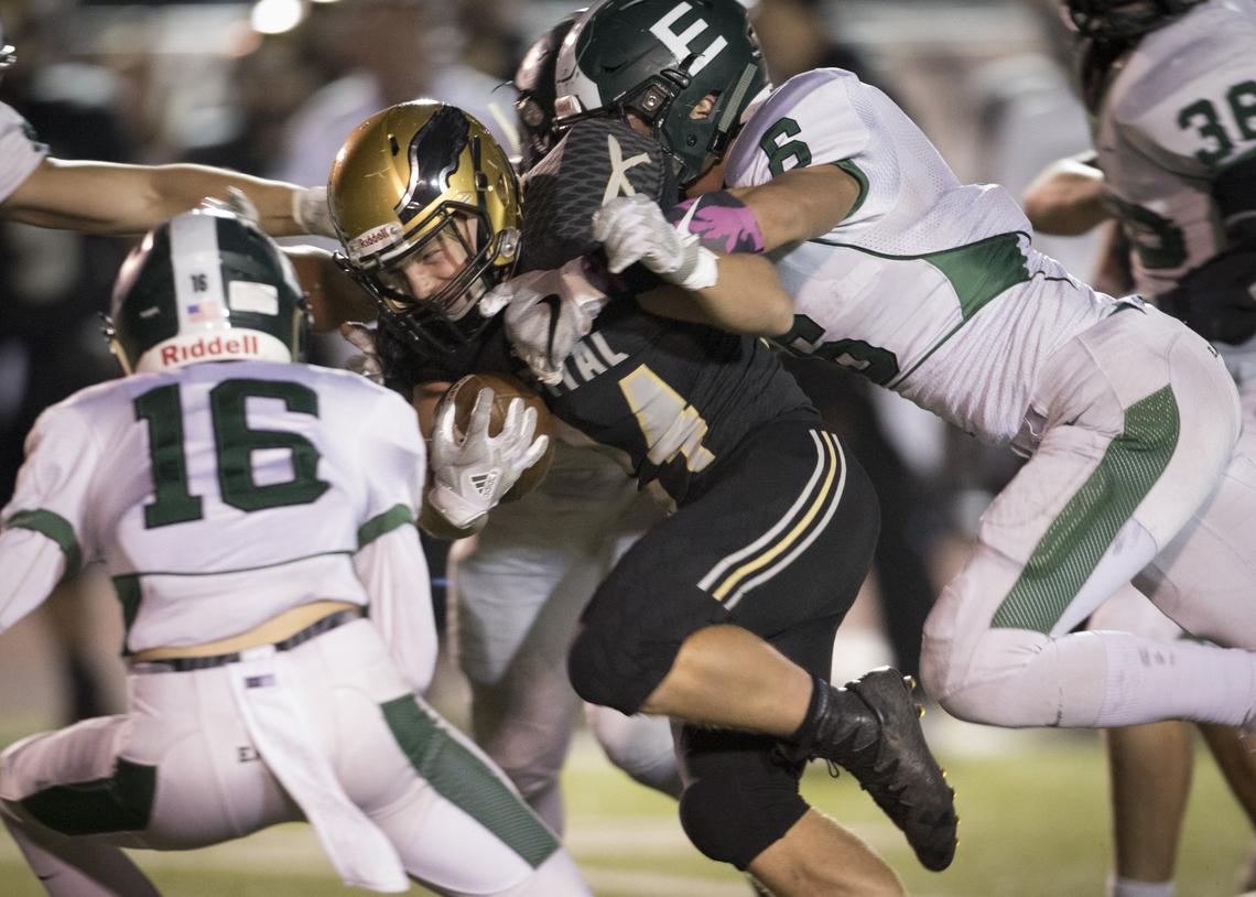 Former Eagle linebacker Matt Hudson, right, drags down Capital’s Jake Jones during a 2018 game at Dona Larsen Park.