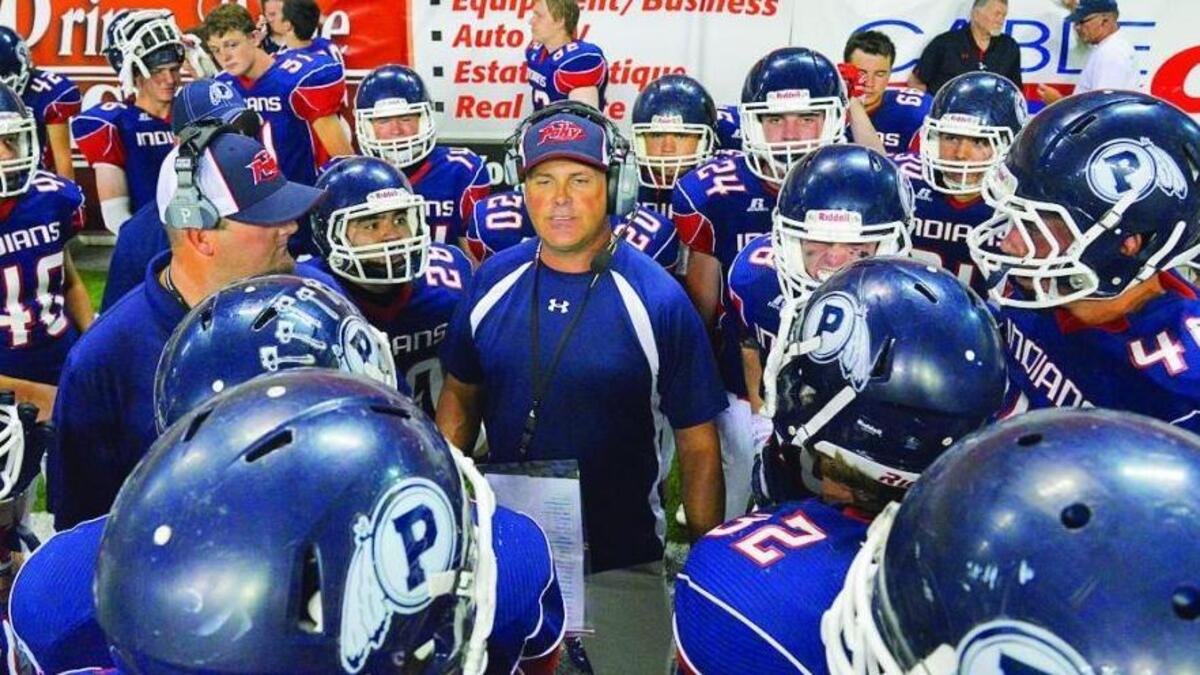 Tom Harrison huddles the Pocatello High football team during a game against Twin Falls at Holt Arena in 2014.