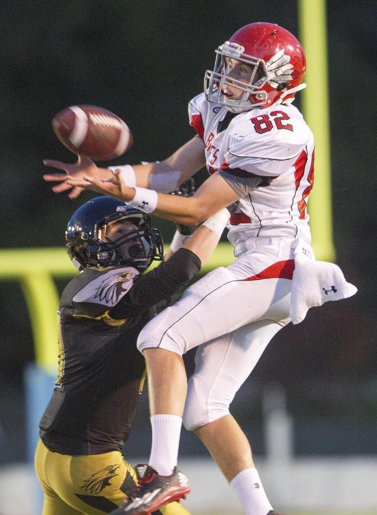 Boise receiver Will Radice, right, hauls in a pass over Capital’s Carter Johnson last season at Dona Larsen Park.
