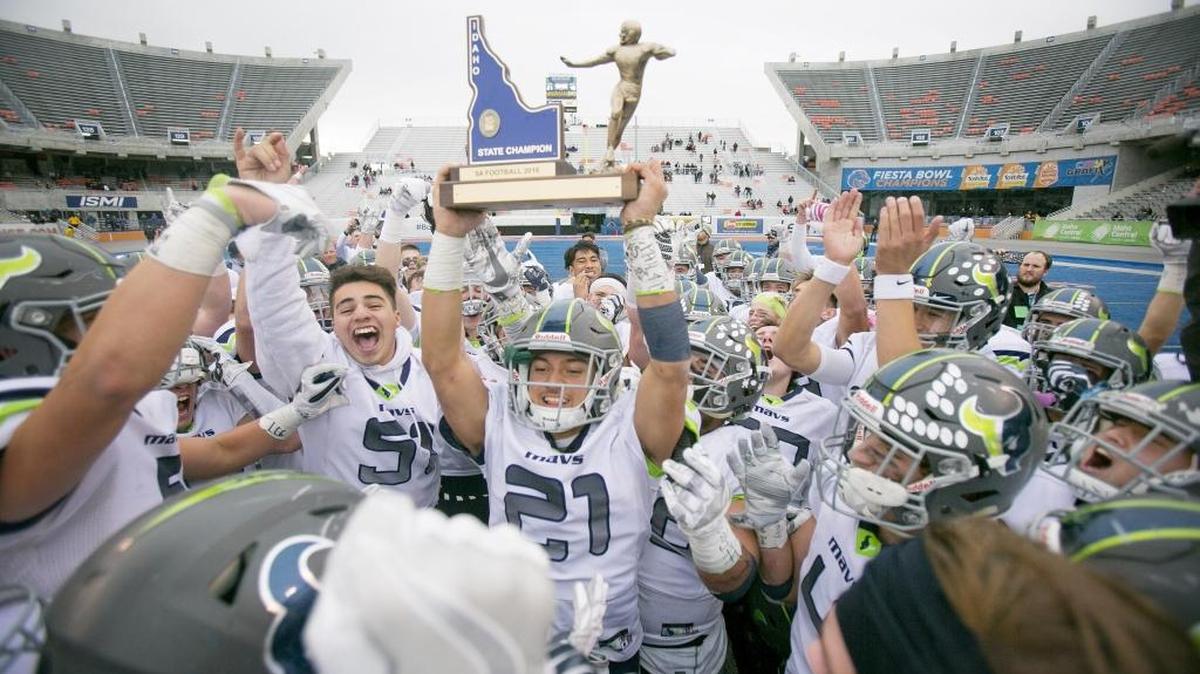Mountain View’s Keenan Pattwell hoists the 5A state championship trophy after the Mavericks beat Capital for the 2016 title at Albertsons Stadium.