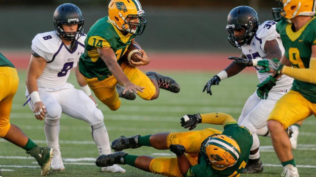 Borah’s llaisa Makaafi jumps over one of his blockers on a run against Rocky Mountain.