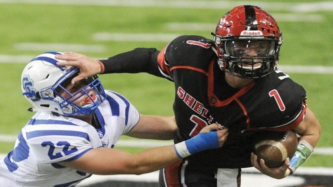 Shelley quarterback Bryon Leckington fights off the tackle of Sugar-Salem linebacker Kyle Ostermiller during the first round of the 3A playoffs at Pocatello’s Holt Arena.
