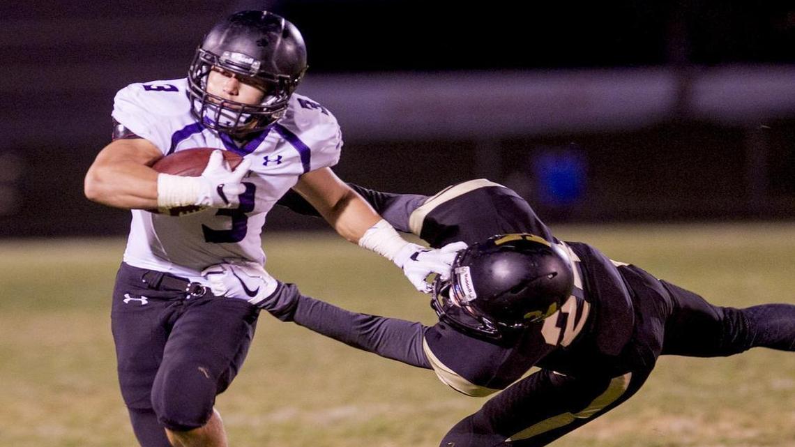 Rocky Mountain running back Carter Kuehl, who rushed for more than 200 yards and scored twice, fights off a tackle by Kuna’s Dalton Bell on Thursday night.