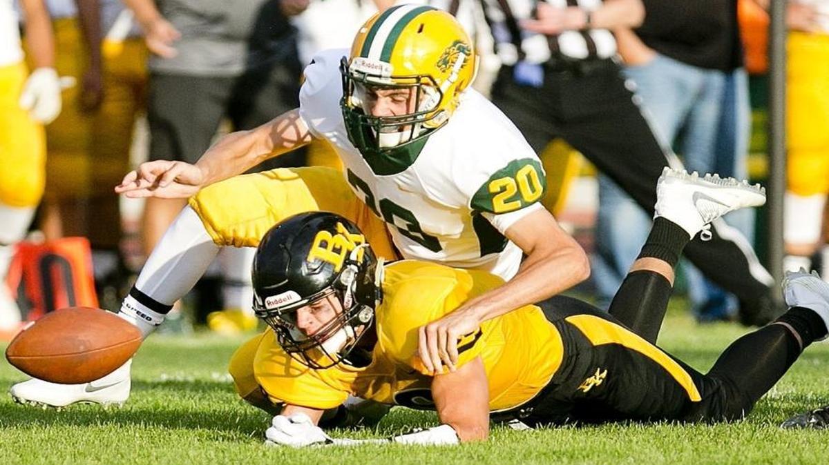 Borah defensive back Chase Nett, top, scrambles for a loose ball last season at Bishop Kelly.
