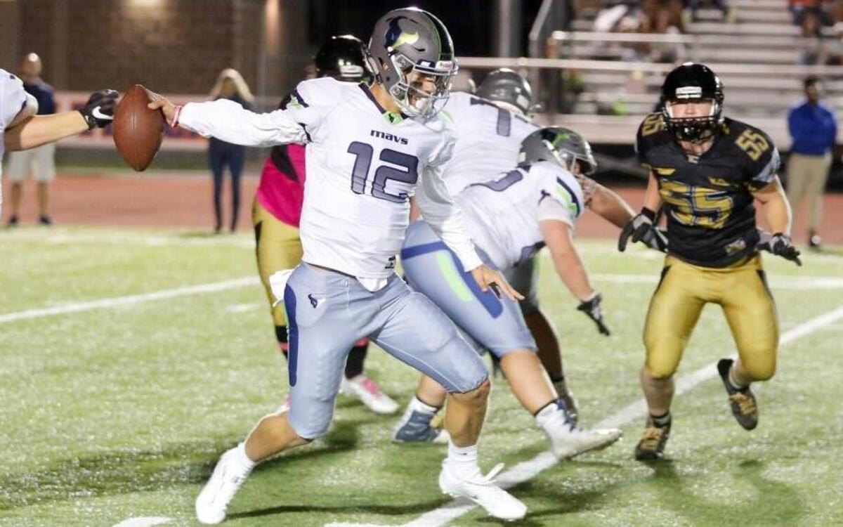 Mountain View quarterback Tucker Rovig escapes a sack against Capital during the final game of the regular season this fall.