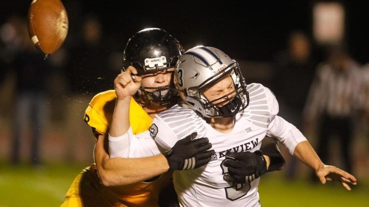 Bishop Kelly’s Daniel Cantrell sacks Skyview’s Wyatt Storer and knocks the ball loose during their game Friday night at Bishop Kelly High.