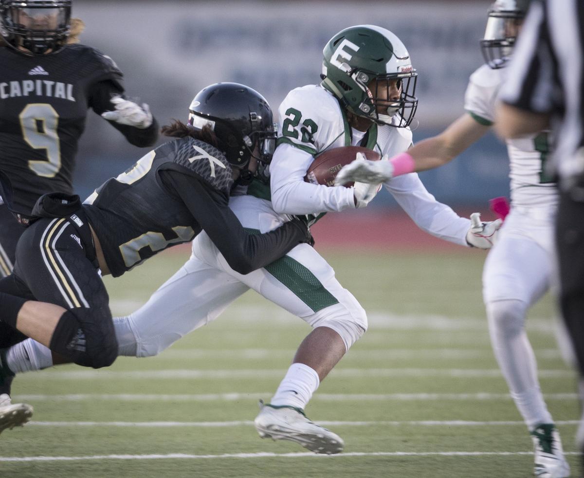 Eagle running back Jackson Stampfli is tackled by Capital’s Hayden Picard. Eagle beats Capital 36-32 at Dona Larsen Park on Thursday, Oct. 11, 2018.
