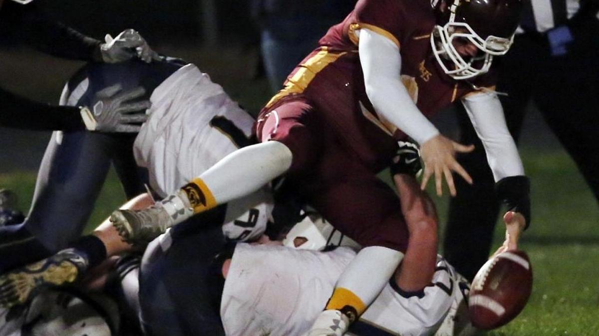 Grangeville defensive lineman TJ Wiltse sacks Nampa Christian QB Steve Tiersma in the 2A semifinals Friday. Tiersma was ruled down before the ball came out.