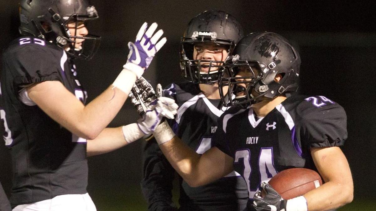 Rocky Mountain’s Nick Romano, right, celebrates his 72-yard touchdown run against Eagle with Brayden Hamilton, left, and Bo Stevens on Oct. 13.
