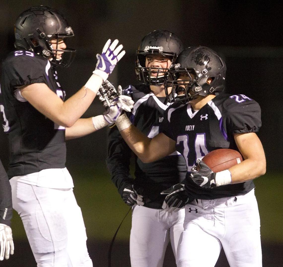 Rocky Mountain’s Nick Romano, right, celebrates a 72-yard touchdown run against Eagle last season.