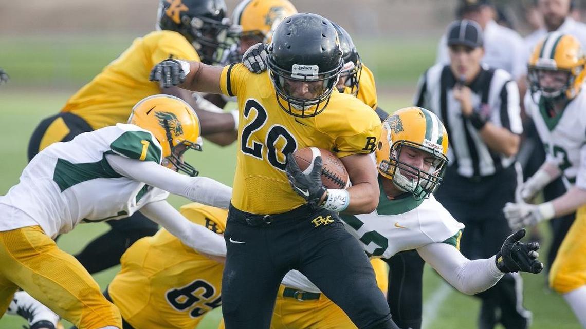Bishop Kelly’s Luke Burley is forced out of bounds by Borah’s Jaden Cavener during Friday’s game at Bishop Kelly High.