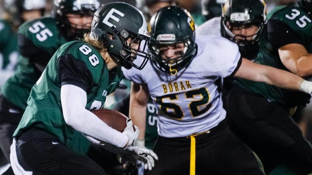 Eagle’s Karl Thomas looks for running room Friday in the first round of the 5A playoffs at Eagle High as Borah’s Lucas Langus closes in.