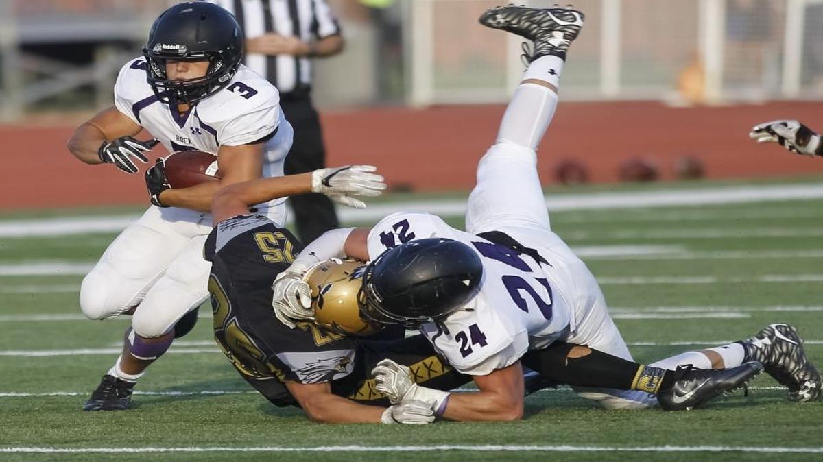 Rocky Mountain’s Carter Kuehl runs the ball against Capital on Sept. 1 at Dona Larsen Park. Rocky Mountain won 38-33.
