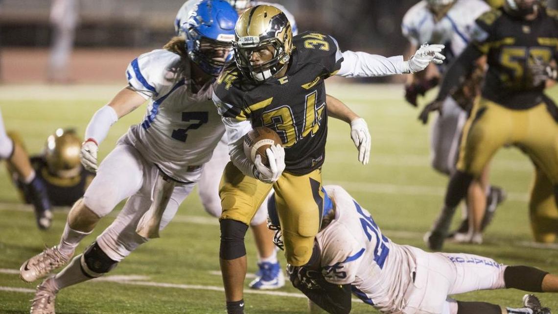 Timberline’s Stone Mason, right, and Dylan Herberg try to drag down Capital’s Sam Sessou-Djokoto during the first round of the 5A playoffs. Timberline qualified for the playoffs as 5A’s lone at-large team. A proposal could create three at-large spots in the 5A field in future years.