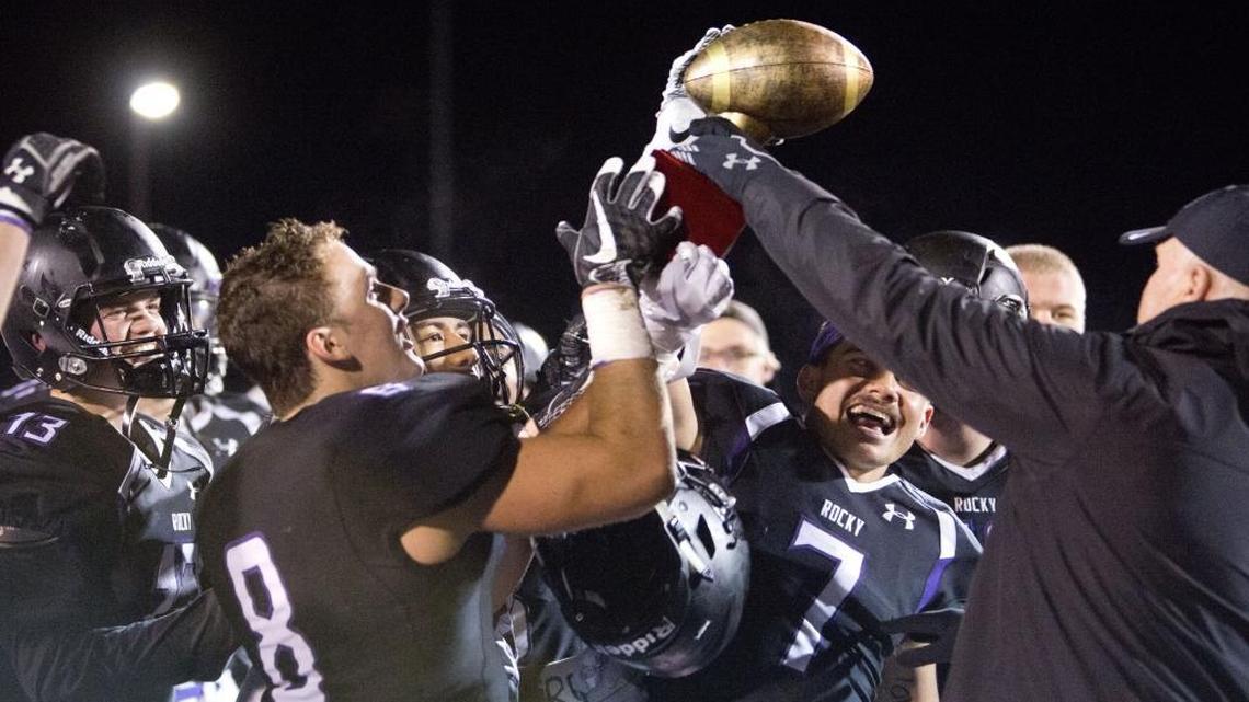 Rocky Mountain is awarded the Herb Criner Bowl trophy Friday from Criner’s son, Scott Criner, after its lopsided win over rival Eagle.