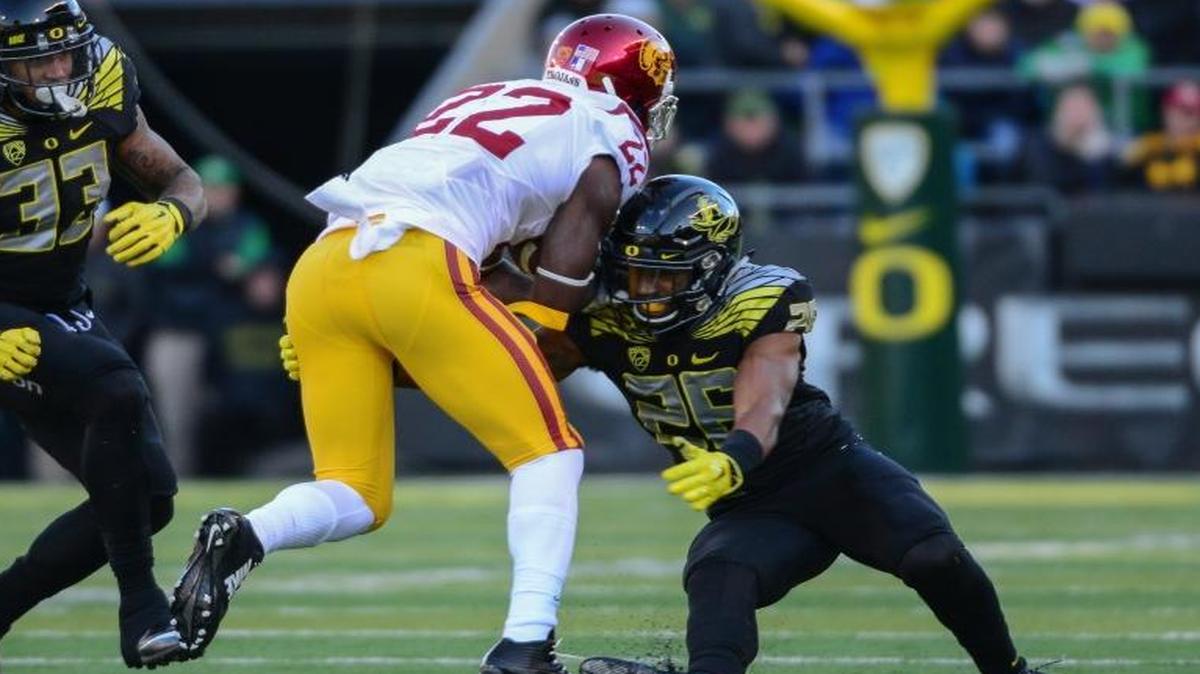 Khalil Oliver, right, makes a tackle in Oregon’s 48-28 win over USC on Nov. 21 at Autzen Stadium. Oliver, a Rocky Mountain High graduate, had four tackles in the game.