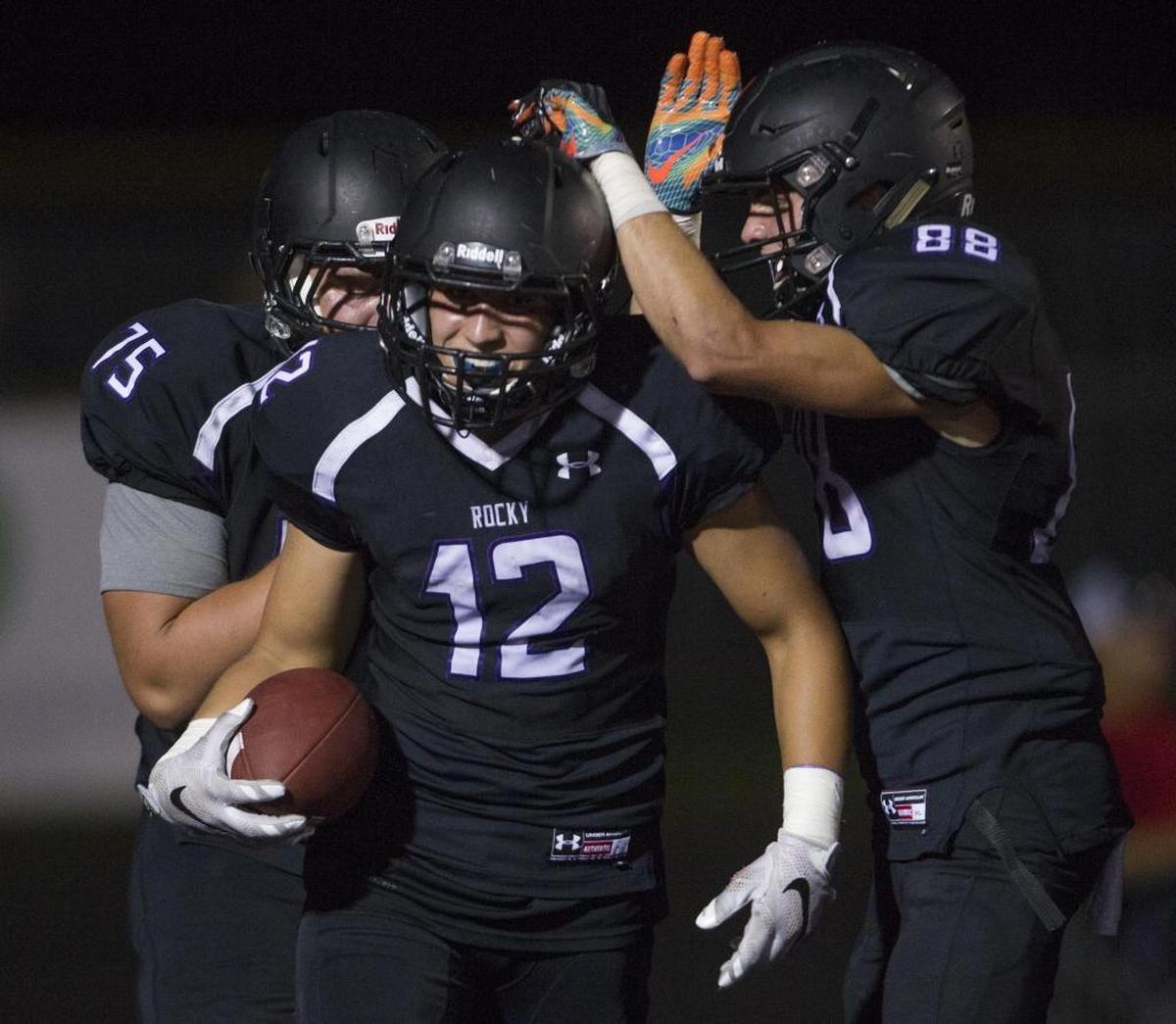 Rocky Mountain’s Bo Stevens is congratulated by teammates after scoring a touchdown against Capital on Sept. 1 at Rocky Mountain High.