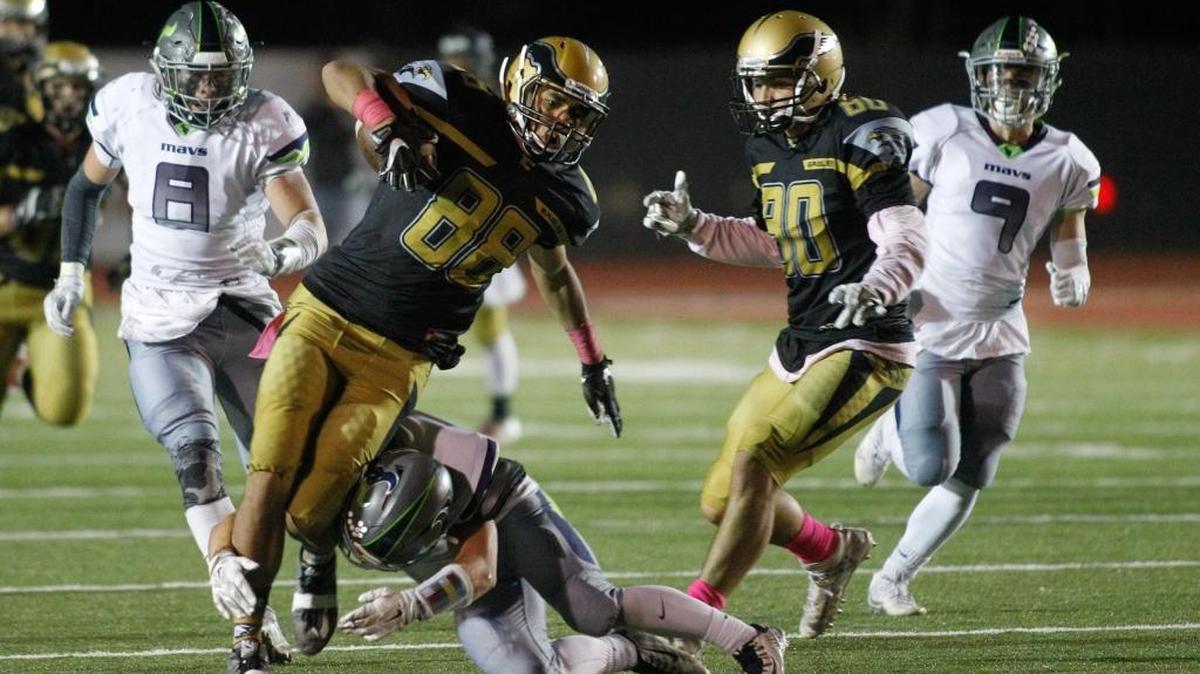 Capital’s Cameron Godney tries to avoid a tackle during Friday night’s game against Mountain View at Dona Larsen Park.