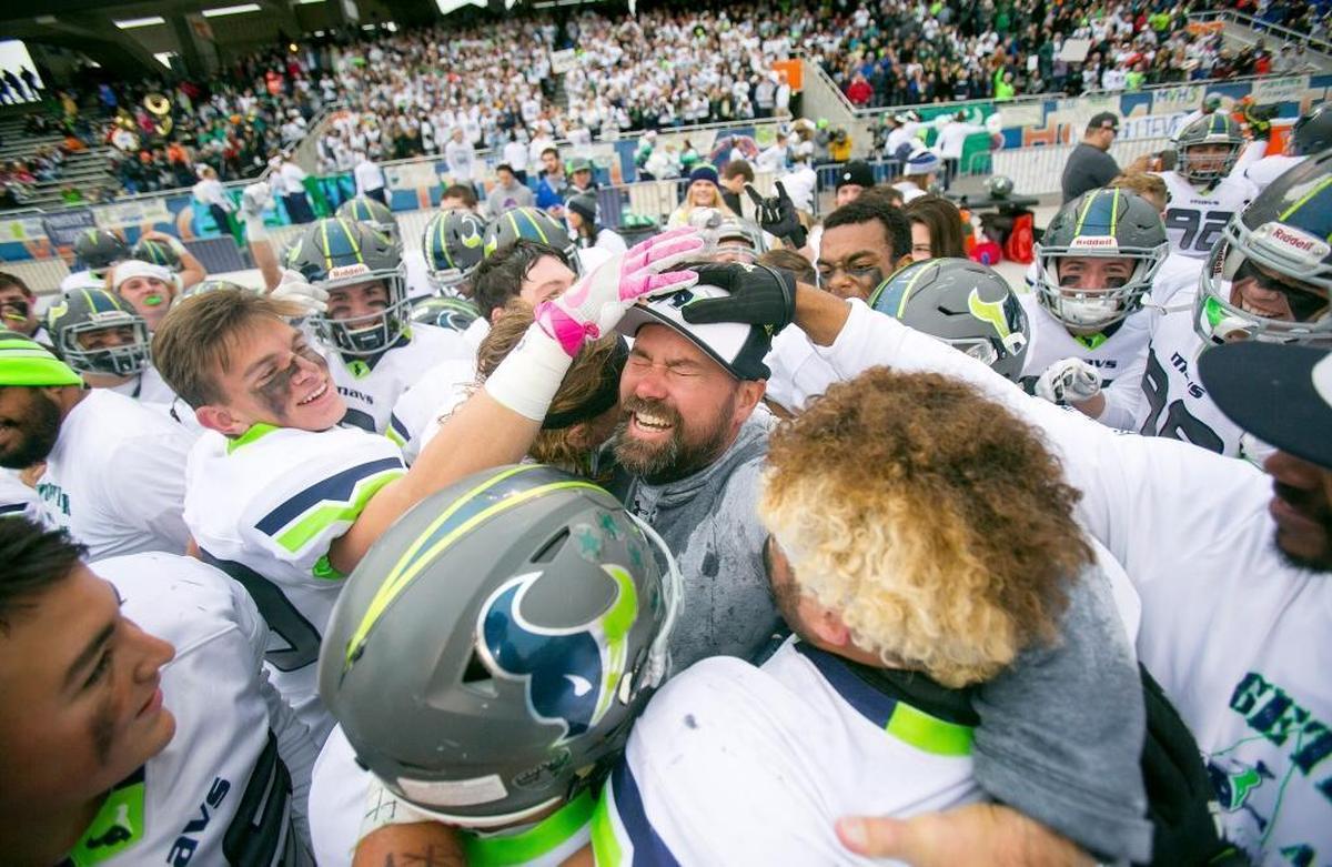 The Mavericks mob Mountain View football coach Judd Benedick after winning the 2016 state championship at Albertsons Stadium.