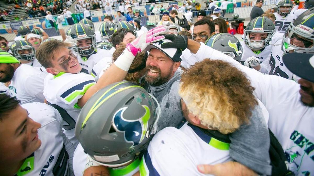 The Mavericks mob Mountain View coach Judd Benedick after winning the 2016 5A state title over Capital at Albertsons Stadium.