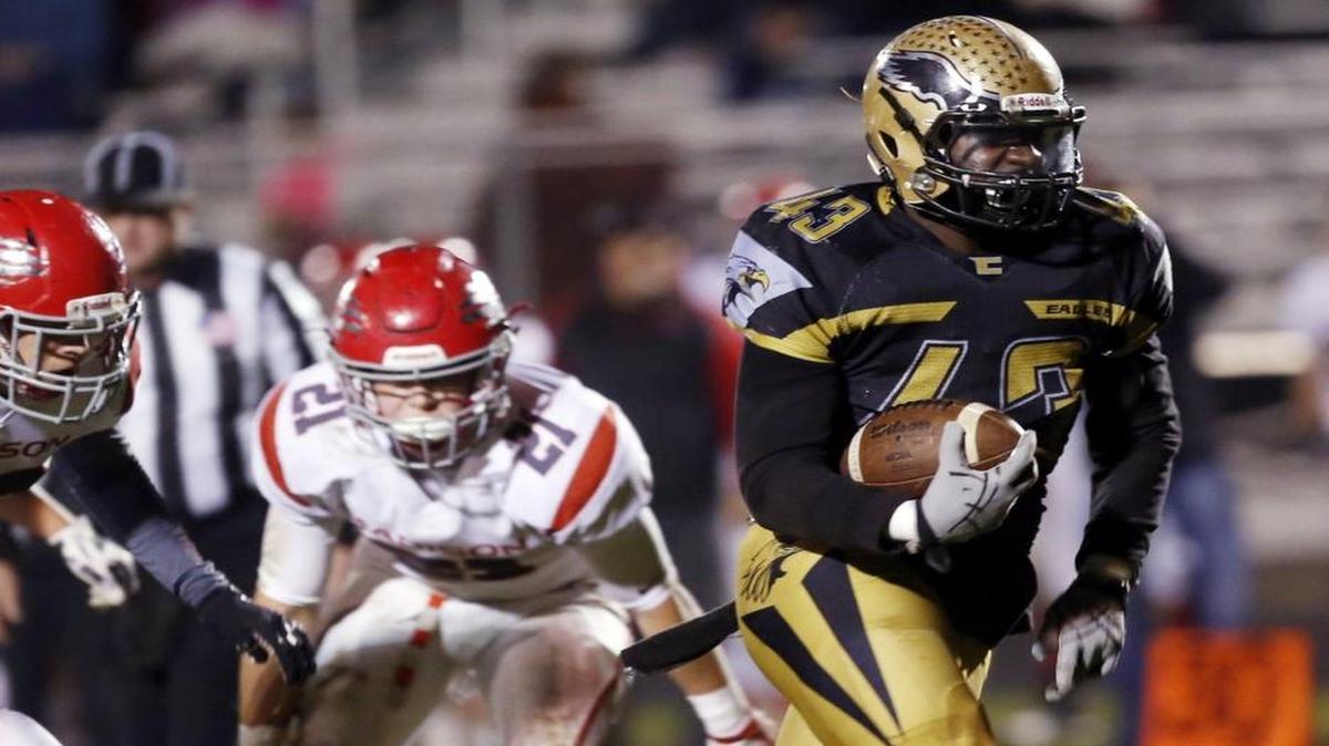 Capital’s Micah Hagler heads upfield for a second-half touchdown against Madison during the 5A state quarterfinals Friday night at Centennial High.