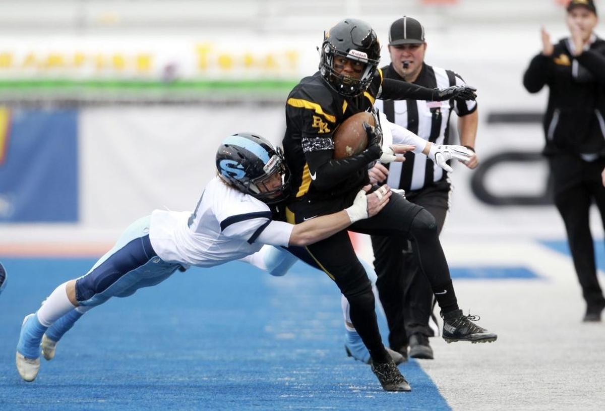 Bishop Kelly’s Khalil Forehand tiptoes down the sideline during the 4A state championship game last season. Forehand has a scholarship offer from Idaho.