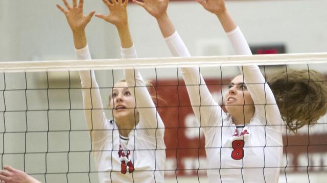 Boise’s Bella Williams, left, and Gabrielle Klinge try for a block against Kuna on Oct. 11 at Boise High.