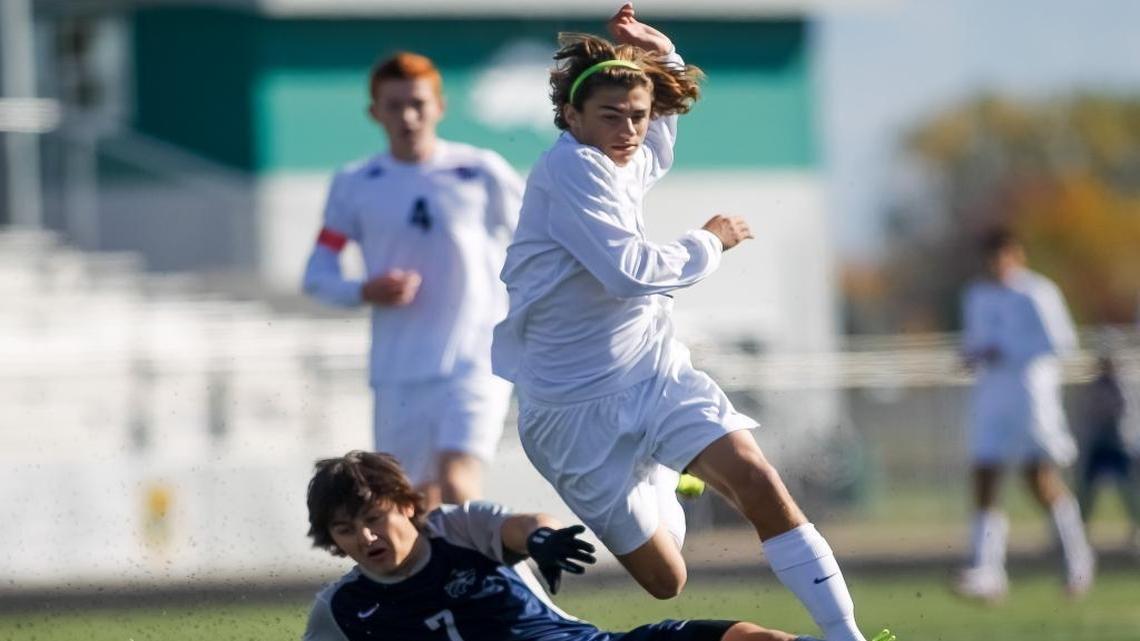 Rocky Mountain’s Jonah Dalmas leaps over Lake City’s Garrett Flolo during the 2015 state tournament at Eagle High.