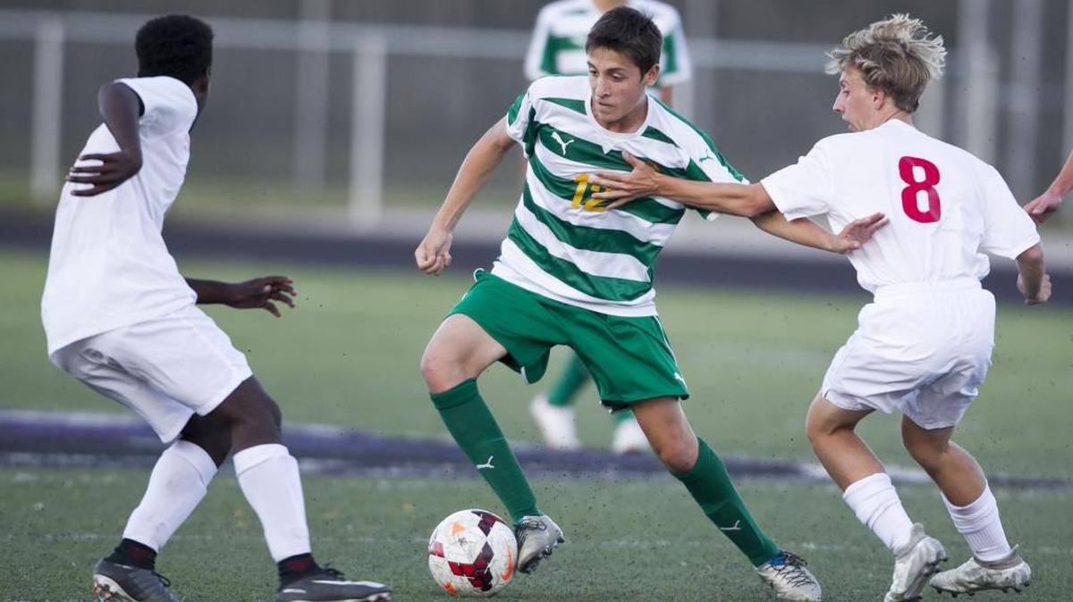 Boise’s Sami Marquez, left, and Carter Luthy try to contain Borah’s Armin Hasanovic during the 5A District Three championship Oct. 11 at Rocky Mountain High.