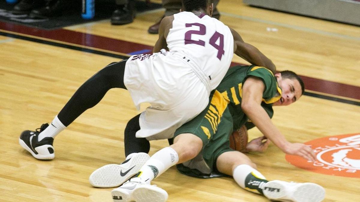 Centennial’s Delveion Jackson (top, 24) and Borah’s Rylan Bergersen dive for a loose ball Thursday at Centennial.