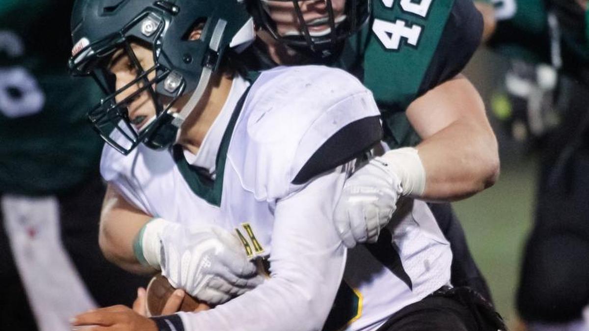 Borah quarterback Hayden Brown is sacked by Eagle’s Luke Leonnig on Friday in the first round of the 5A state football playoffs in Eagle. Eagle won 39-29.