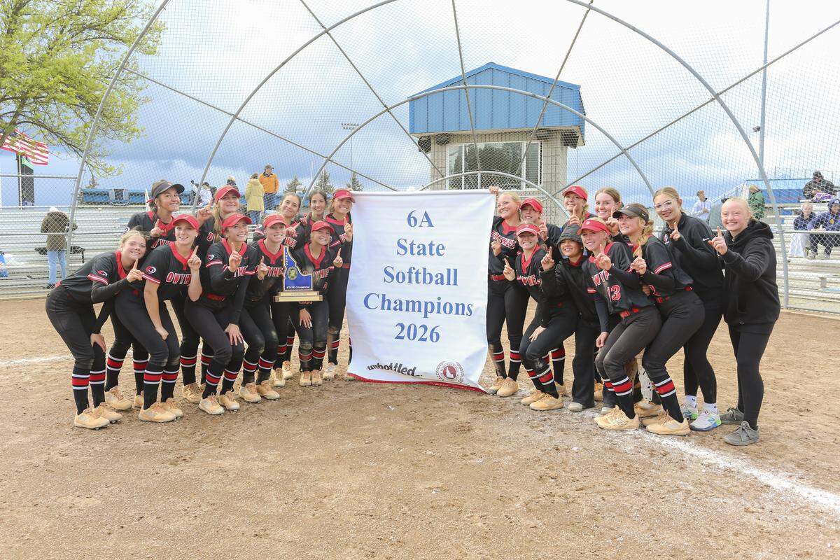 Owyhee poses with its second straight 6A softball state championship banner Saturday at Coeur d’Alene High.