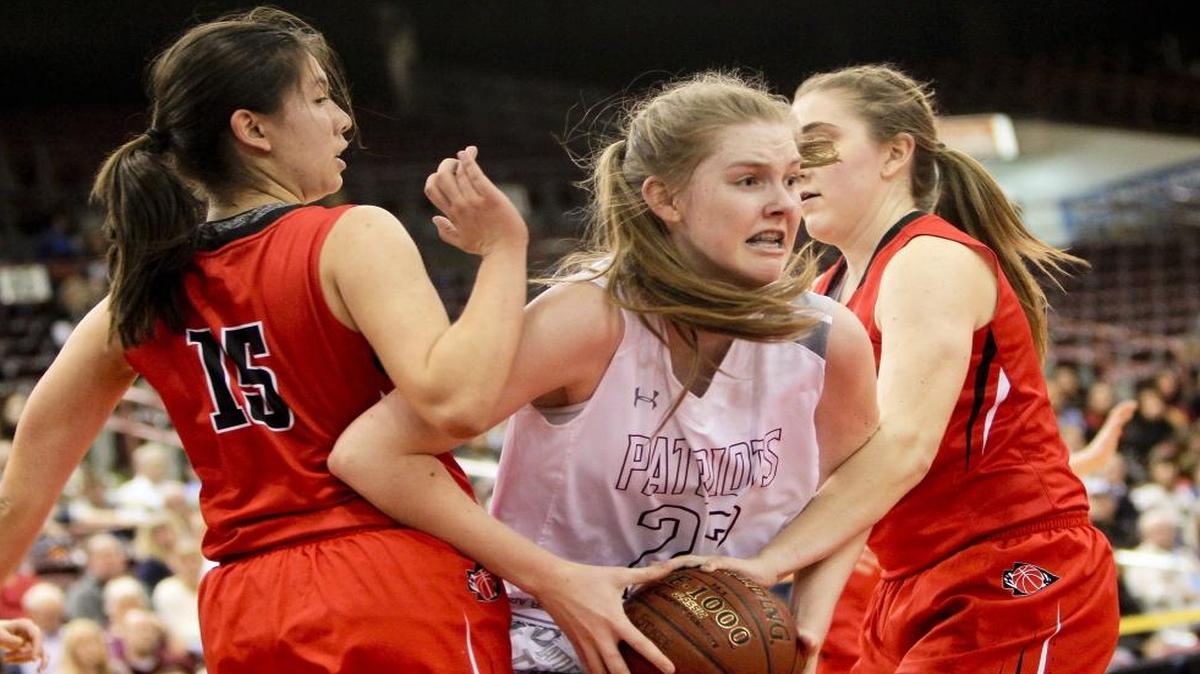 Centennial’s Lauren Brocke, center, drives past Boise’s Claire Bonnet, left, and Kirsten Robinson during the 5A state tournament Feb. 19 at the Ford Idaho Center in Nampa. Centennial defeated Boise 55-43.