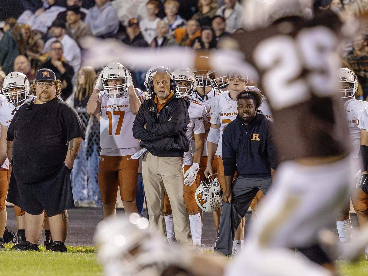 Rocky Mountain hired former Ridgevue coach Gary Thorson, center in black, as its next football coach for the 2026 season. 