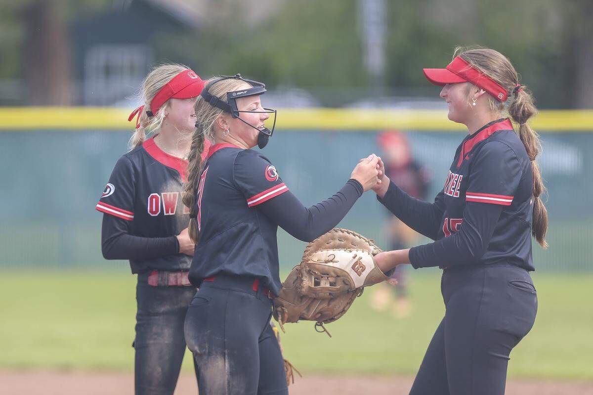 Owyhee’s Hailey Bock, left, and Madalynn Mahaffey celebrate after a strikeout in the championship round of the 6A softball state tournament Saturday at Coeur d’Alene High.