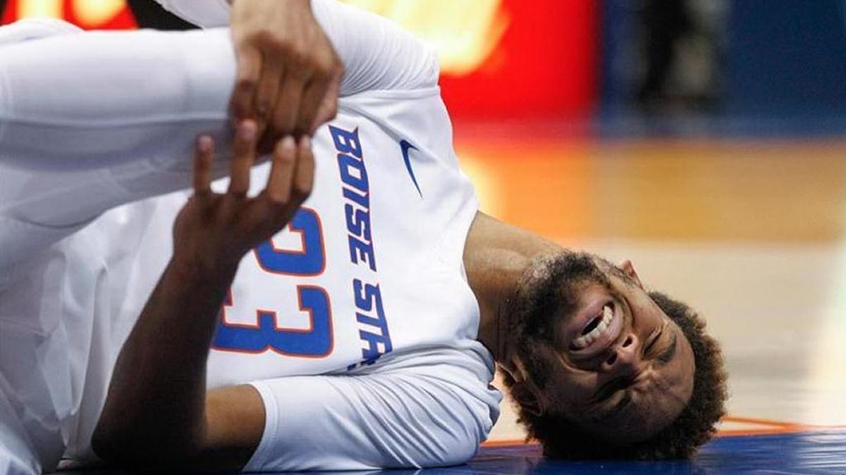 Boise State junior forward James Webb III holds his right knee later in the second half Tuesday against UNLV at Taco Bell Arena. He had an evaluation Wednesday, but his status is unknown for Saturday at San Diego State.