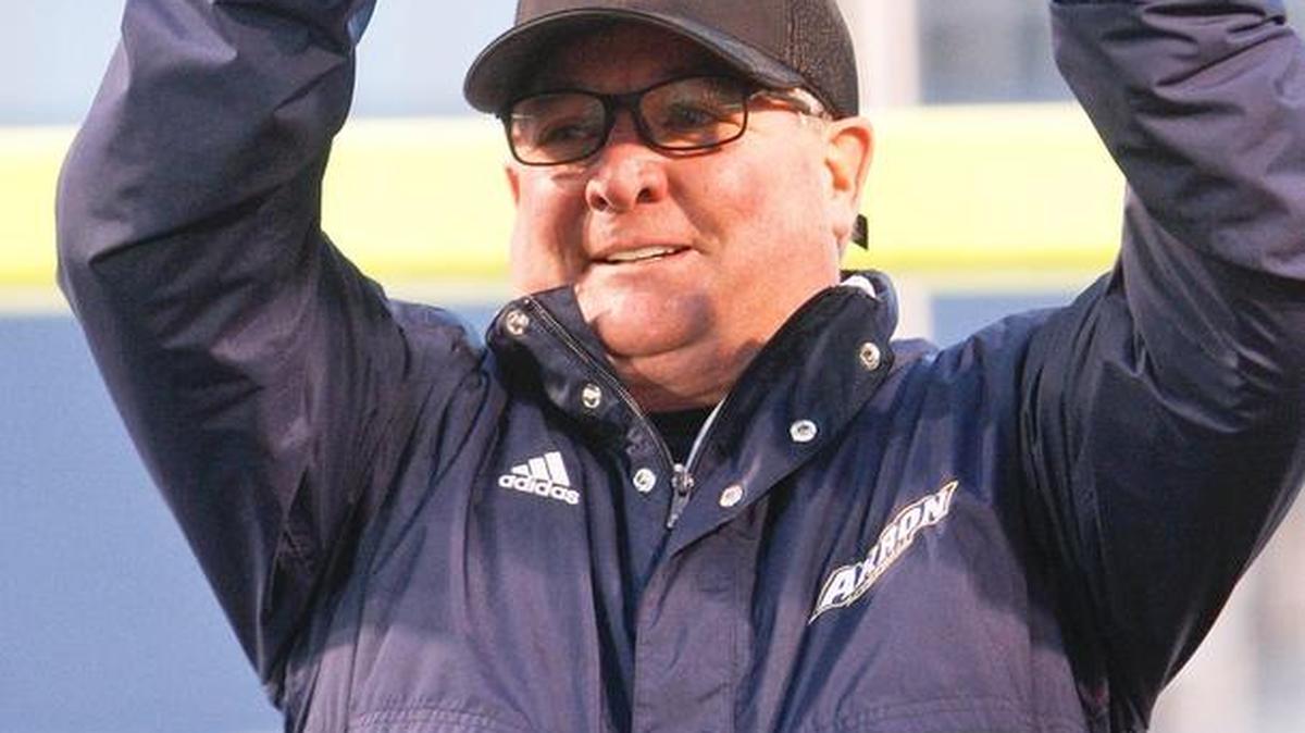 Akron football coach Terry Bowden holds a trophy (filled with potatoes) after winning the Famous Idaho Potato Bowl at Albertsons Stadium in Boise. Akron defeated Utah State 23-21.