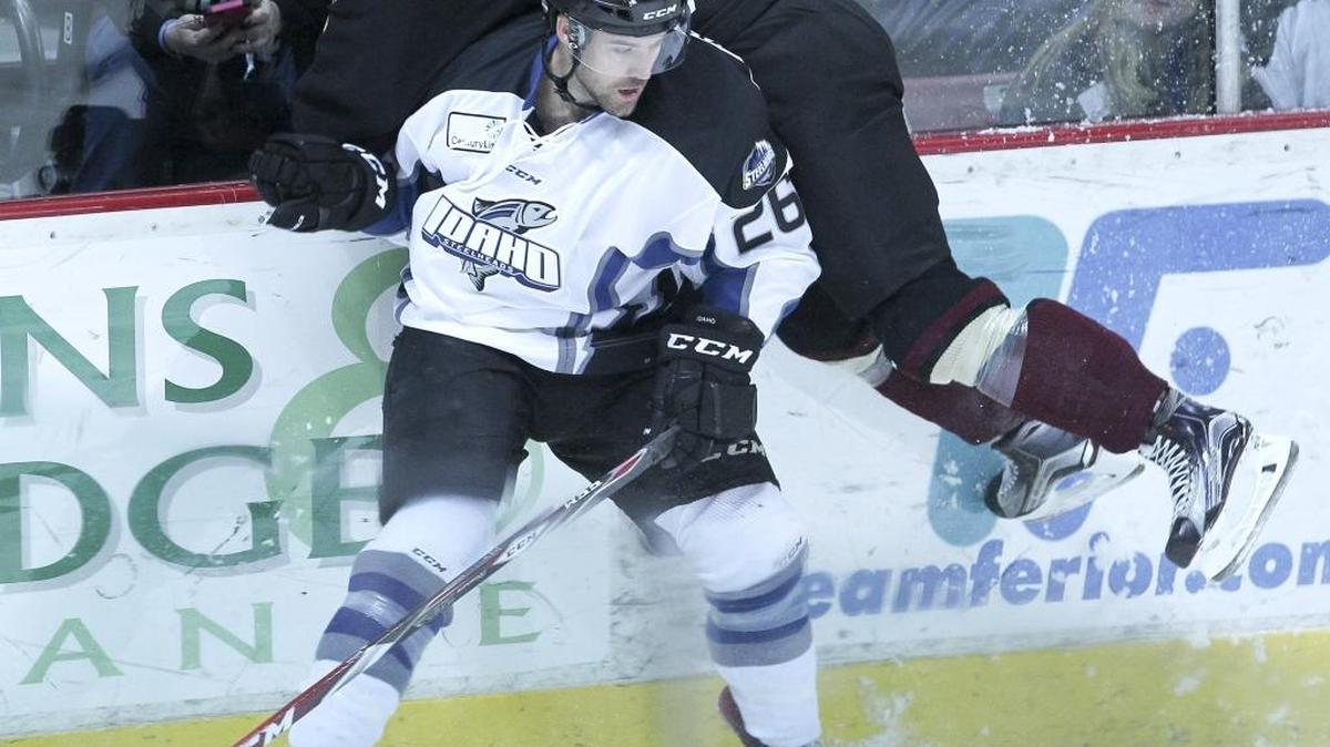 Idaho Steelheads player Rob Linsmayer (26) checks Atlanta Gladiators player Ian Barteaux (25) during an ECHL hockey at CenturyLink Arena in Boise, Idaho. Wednesday November 4, 2015