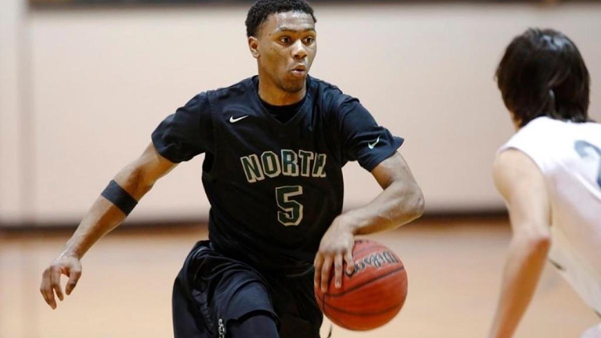 Norman North guard Marcus Dickinson drives around a Shawnee defender during the Timberwolves’ 83-58 first round win at the Shawnee Invitational Basketball Tournament at Shawnee High School on Jan. 22, 2015.