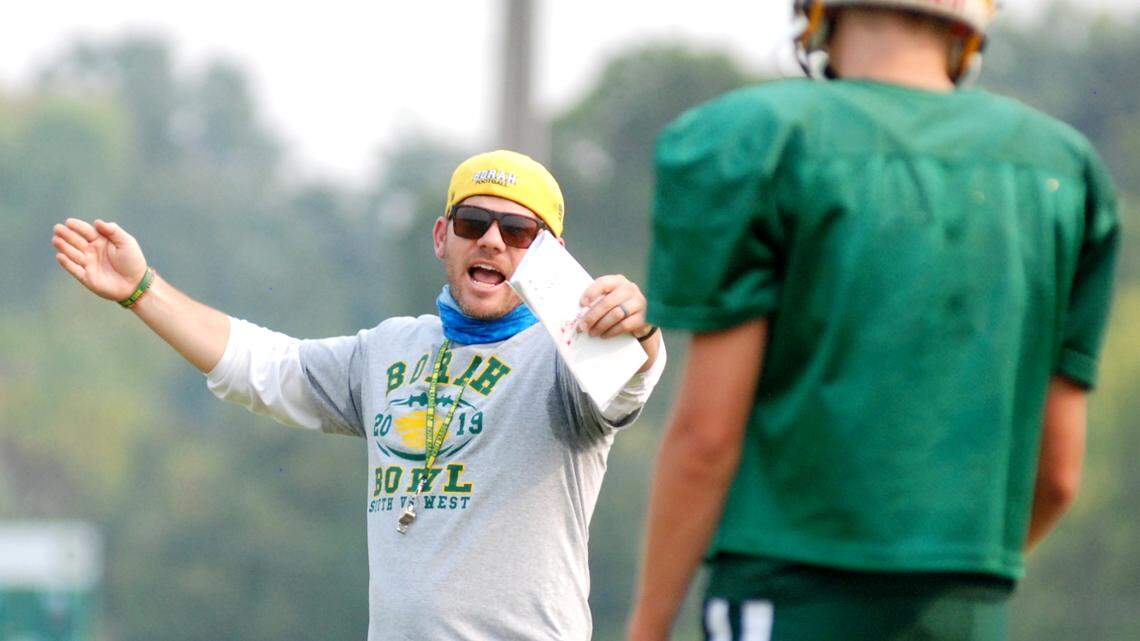 Borah football coach Jason Burton leads his team through a walkthrough practice Wednesday, Sept. 16, under smoky skies. The Lions plan to open the season Friday at Timberline.