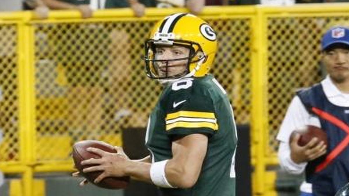 Green Bay Packers quarterback Taysom Hill scrambles past the Philadelphia Eagles’ Alex McCalister during the second half of a preseason NFL football game Thursday in Green Bay, Wis. The Packers won 24-9.