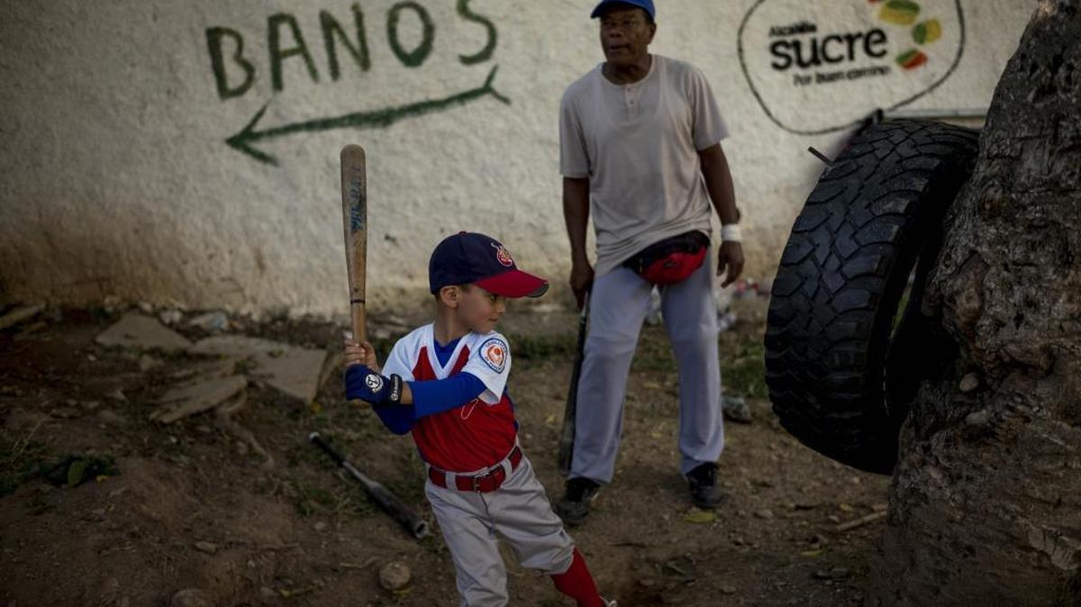 A student at the Yogui Baseball School practices his swing on a tire near the Las Brisas barrio in East Caracas, Venezuela, on Oct. 5, 2015. The dream of playing in the major leagues draws children across Venezuela into baseball, helping them develop discipline, work ethic and communication skills.