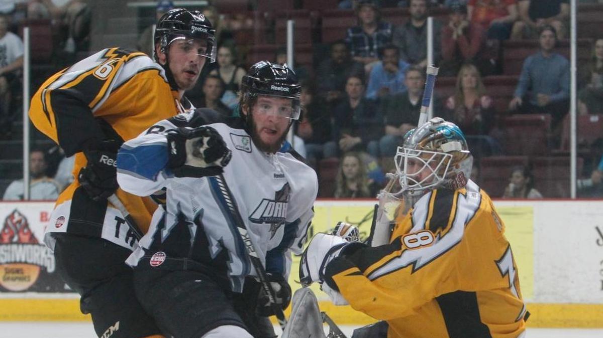 Stockton Thunder goalie Olivier Roy is drawn away from the net by the Idaho Steelheads’ Andrew Carroll in the first game of the ECHL Western Conference finals on May 3, 2013, in Boise.