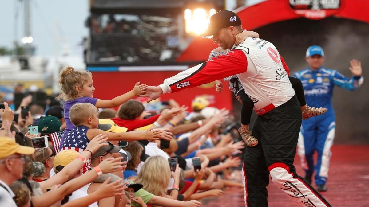 Boise NASCAR driver Brian Scott and his step-daughter Brielle are greeted by fans during driver introductions before the start of the NASCAR Sprint Cup race at Daytona International Speedway, Saturday, July 2, 2016, in Daytona Beach, Fla.