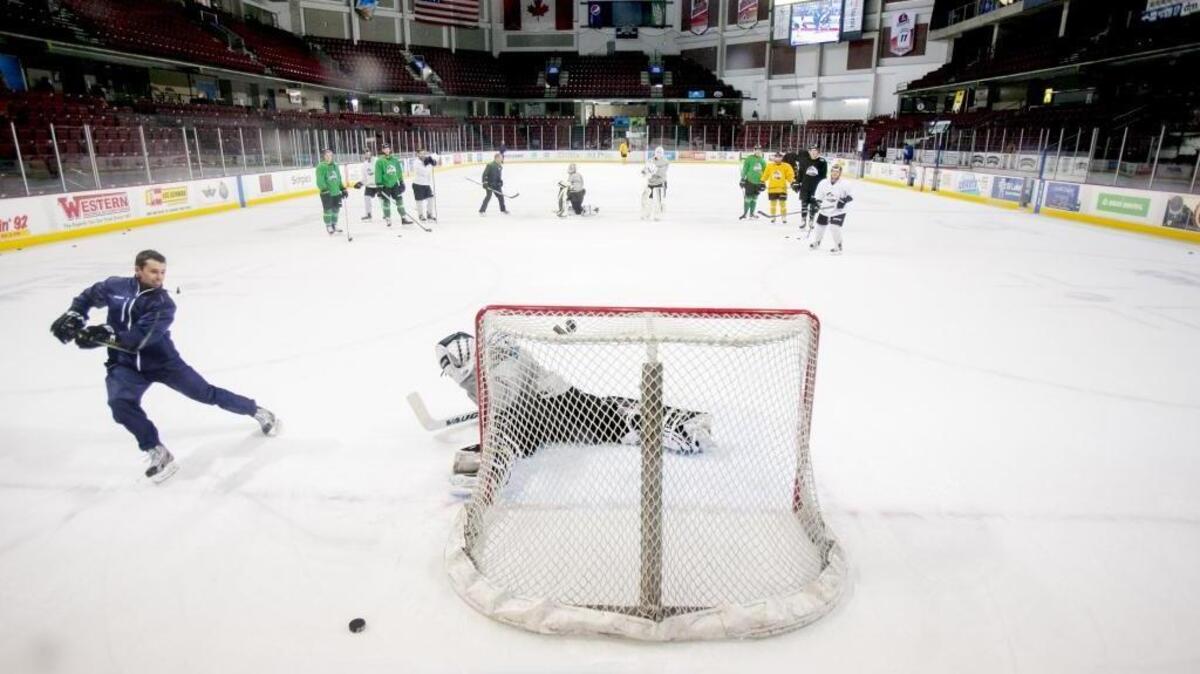 Idaho Steelheads head coach Neil Graham takes a shot on goalie Branden Komm during practice at CenturyLink Arena.