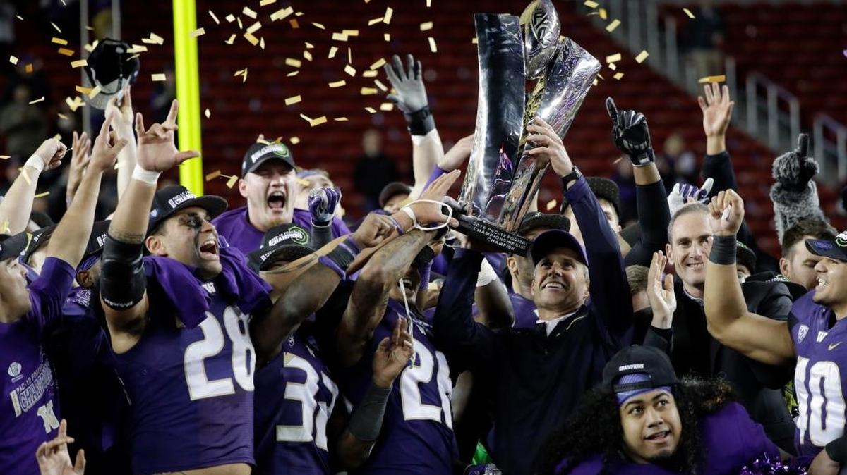 Washington coach Chris Petersen holds the trophy after Washington’s 41-10 win over Colorado in the Pac-12 football championship game Friday, Dec. 2, 2016, in Santa Clara, Calif.