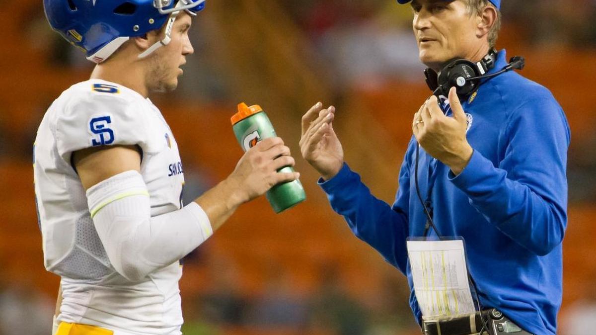 San Jose State football coach Ron Caragher talks to quarterback Kenny Potter during their game Saturday, Nov. 21, 2015, in Honolulu. The Spartans’ offense is averaging 28.5 points and 409.1 yards a game.