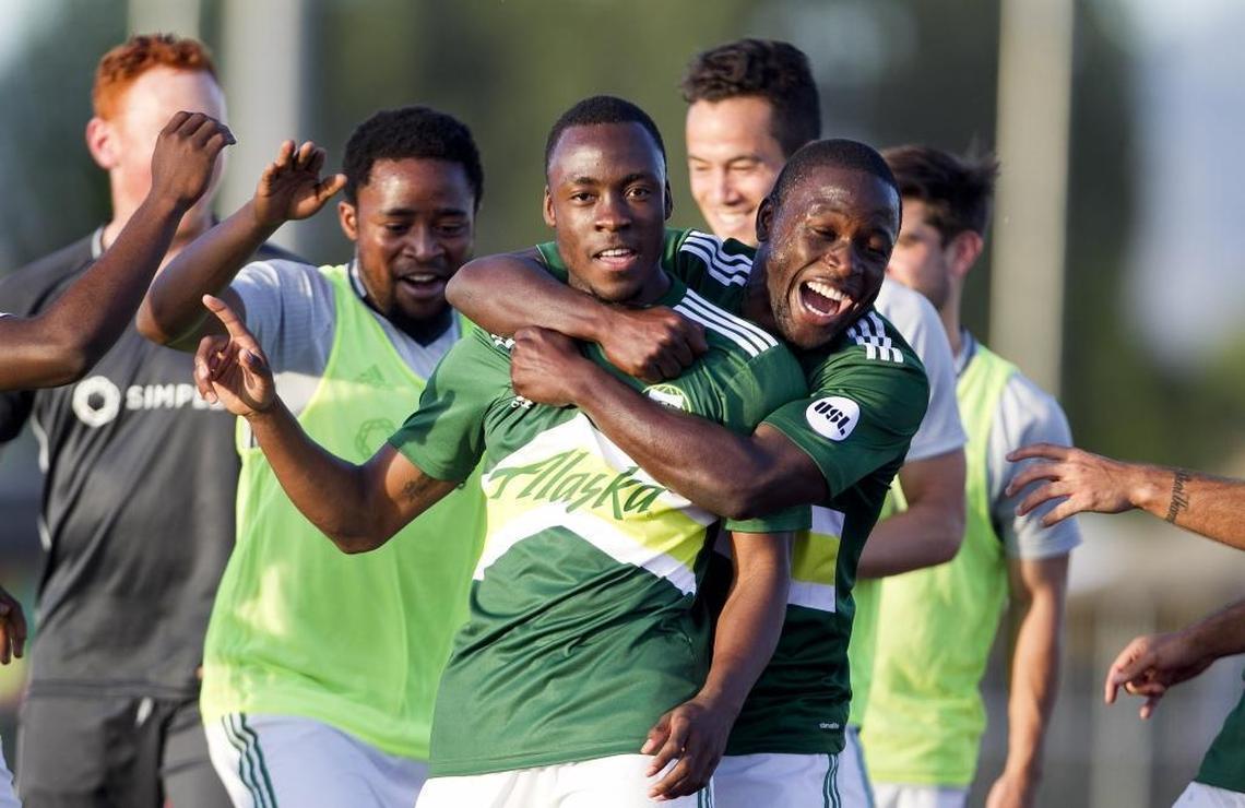 Portland Timbers 2 soccer player Victor Arboleda (73, front) gets a hug from teammate Neco Brett (25, right) after Arboleda scored the eventual winning goal against the Swope Park Rangers during the soccer match held at Rocky Mountain High School on June 4, 2016. Portland Timbers 2 defeated the Swope Park Rangers 2-1.
