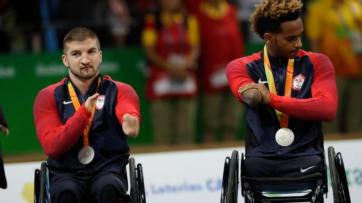 The United States’ Kory Puderbaugh, left, and Josh Brewer applaud as they attend the medal ceremony with their silver medals after the mixed wheelchair rugby final match with Australia at the Paralympic Games in Rio de Janeiro, Brazil, on Sunday. Australia won the gold medal.